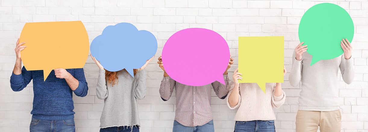 Group of People Holding Speech Bubble in Front of Faces